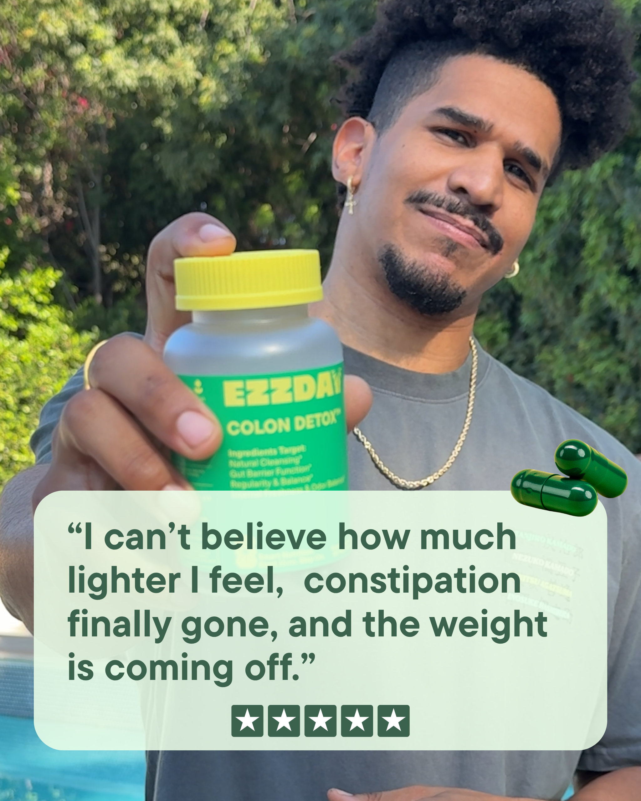 Man holding a EZZDAY colon detox supplement bottle with yellow cap and green capsules