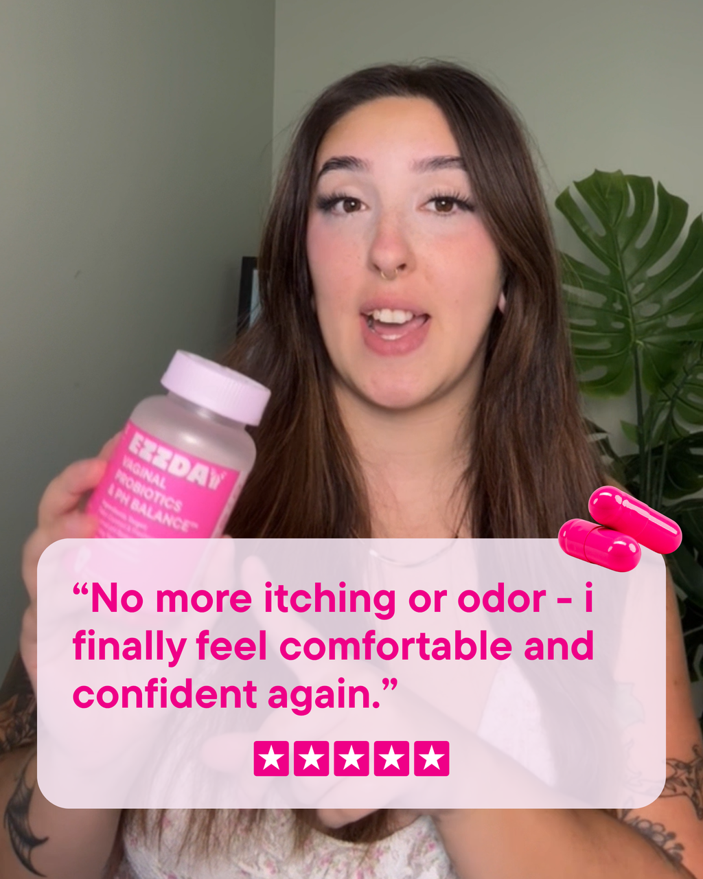 Woman holding a vaginal probiotic capsule bottle with pink capsules beside her