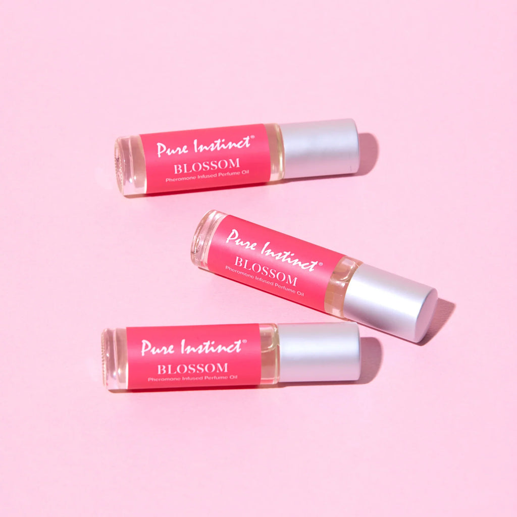 Set of Pink Blossom pheromone roll-ons with silver caps and red labels