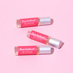 Set of Pink Blossom pheromone roll-ons with silver caps and red labels
