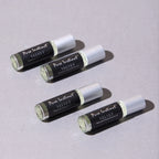 Set of velvet pheromone roll-on bottles with silver caps and black labels