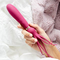 Pink handheld personal massager with curved tip and looped handle cord