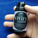 Vivify tightening gel bottle held in hand, black cap and label