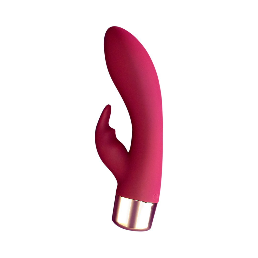 Pink silicone personal massager with curved head and gold-tone battery end