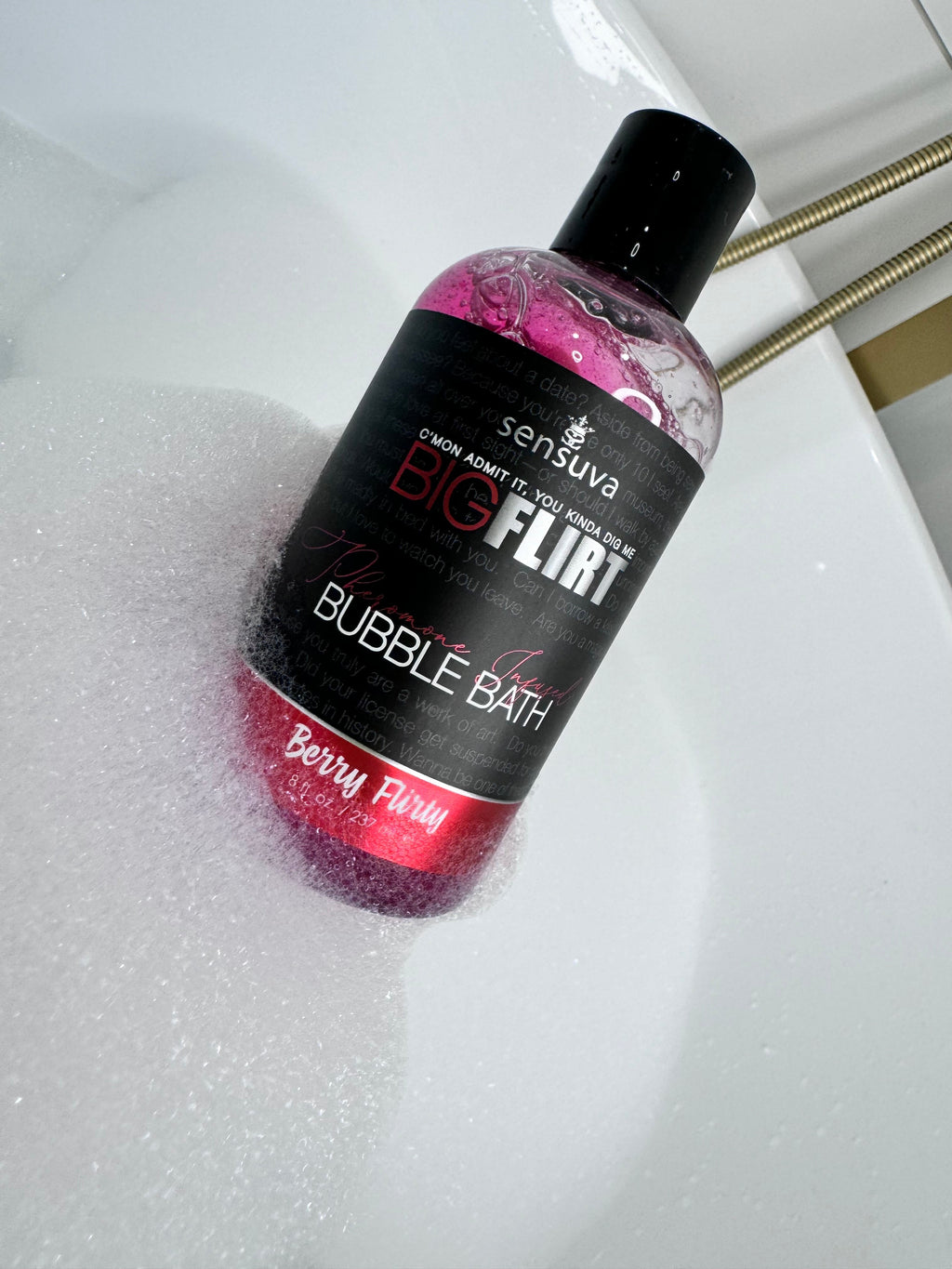 Bubble bath bottle with black cap, pink gel, labeled “Berry Flirty”