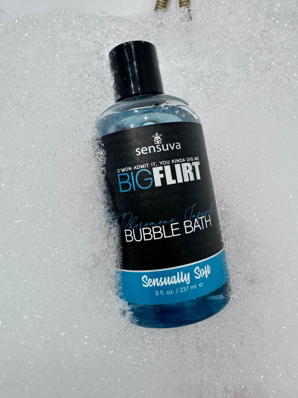 Bubble bath bottle with black cap, blue gel, labeled “Sensually Soft”