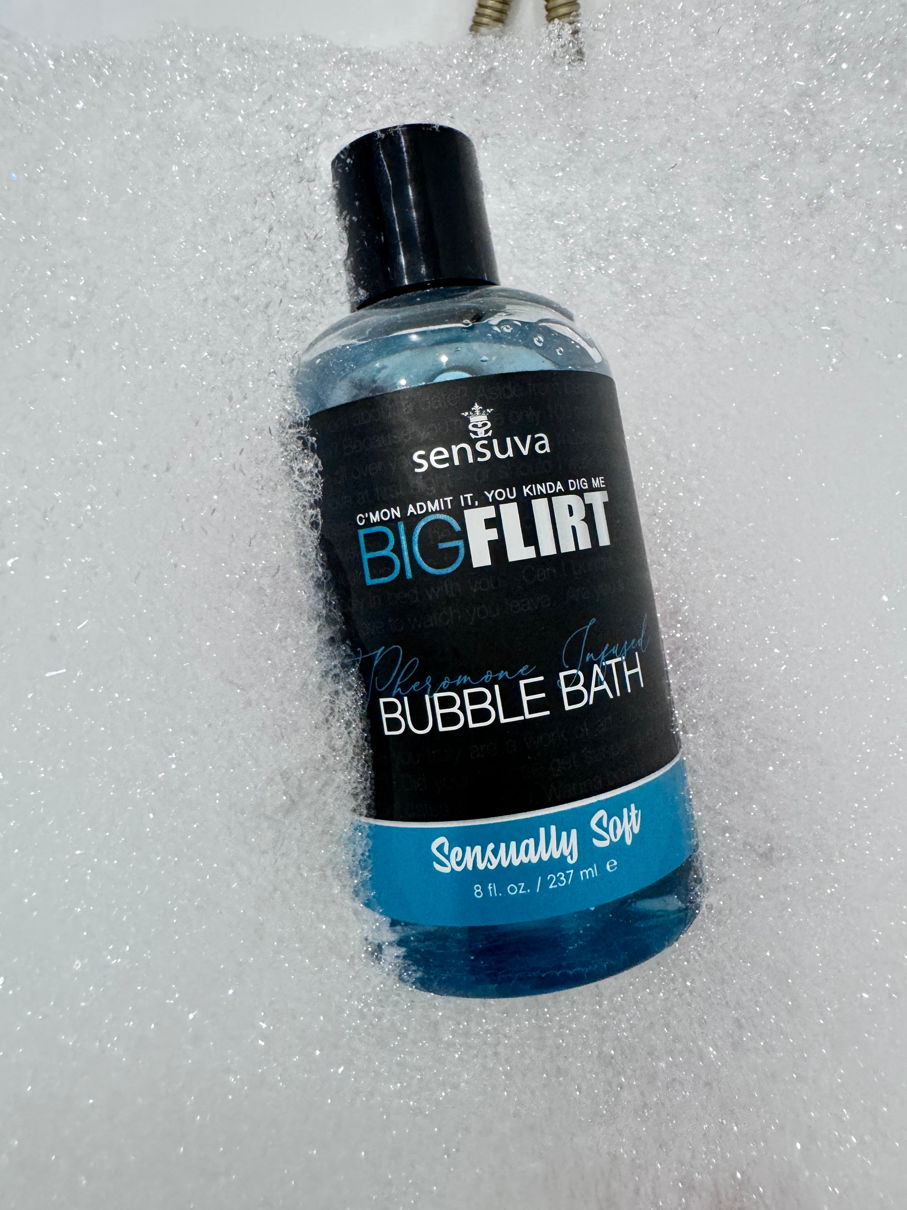 Bubble bath bottle with black cap, blue gel, labeled “Sensually Soft”