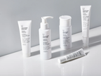 Uncovered Skincare Daily Essentials Kit assorted upright bottles and tubes