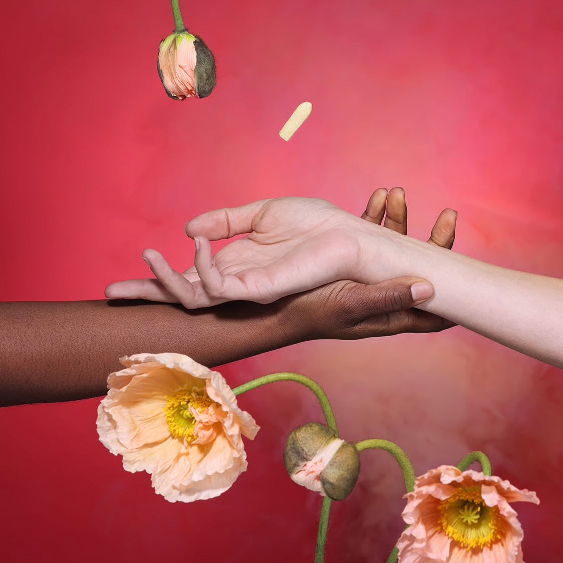 Hands holding a yellow suppository with flower accents