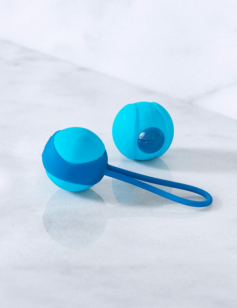 Turquoise hand exercise device with wrist strap and two circular end pieces