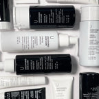 Uncovered Skincare Daily Essentials Kit with black and white bottles and tubes