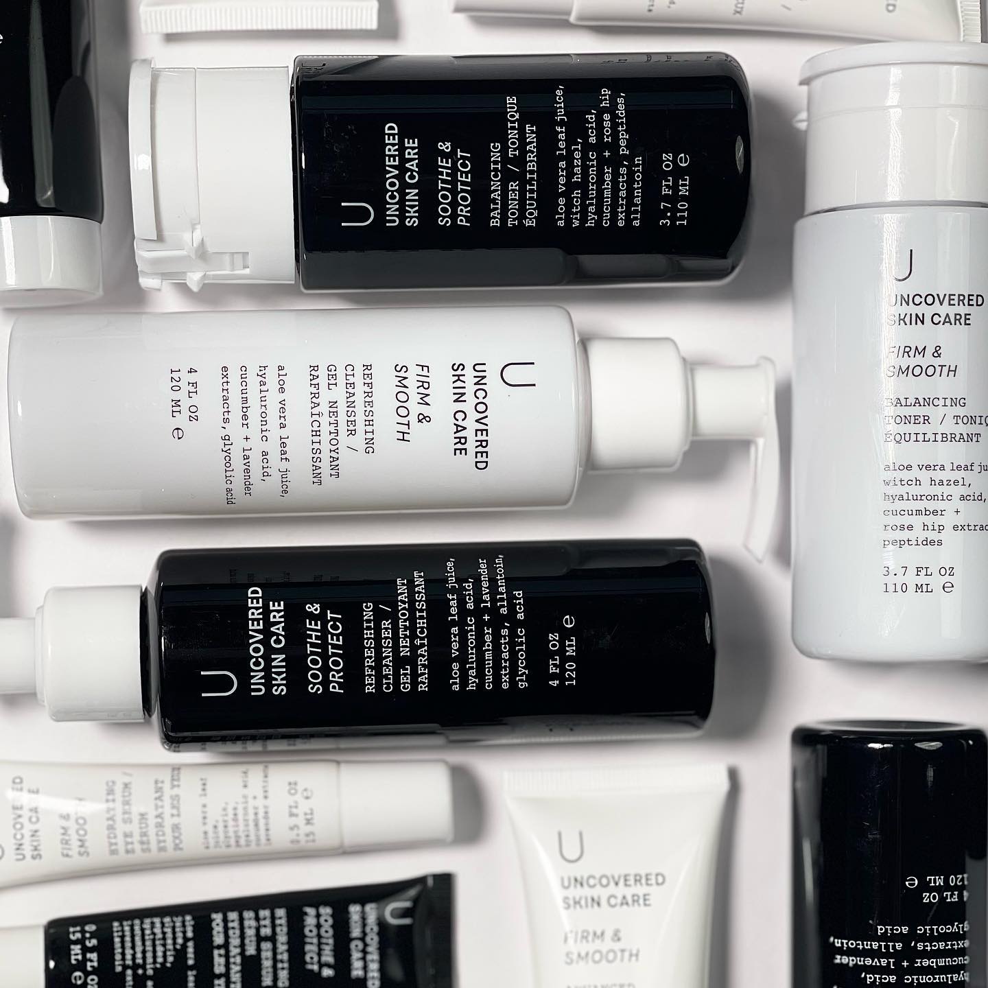 Uncovered Skincare Daily Essentials Kit with black and white bottles and tubes