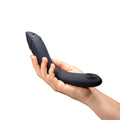 Curved black G-spot vibrator with smooth silicone body, handheld