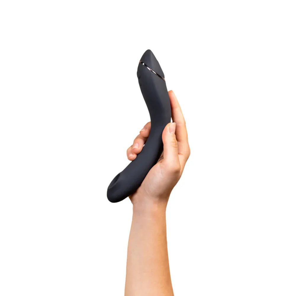 Curved black G-spot vibrator held in hand, angled profile