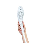 Hand holding power shower head, side view with control button on handle