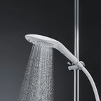 White handheld shower head spraying water stream from nozzle cluster