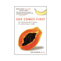 Paperback book cover, She Comes First, with papaya slice illustration and black seed design