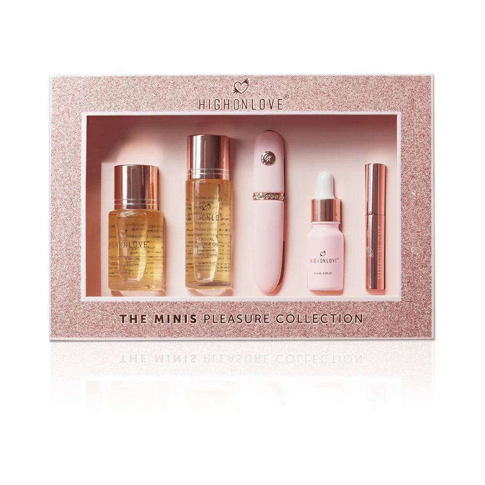 Boxed mini fragrance set with four pink and gold bottles and rose-gold sticks.