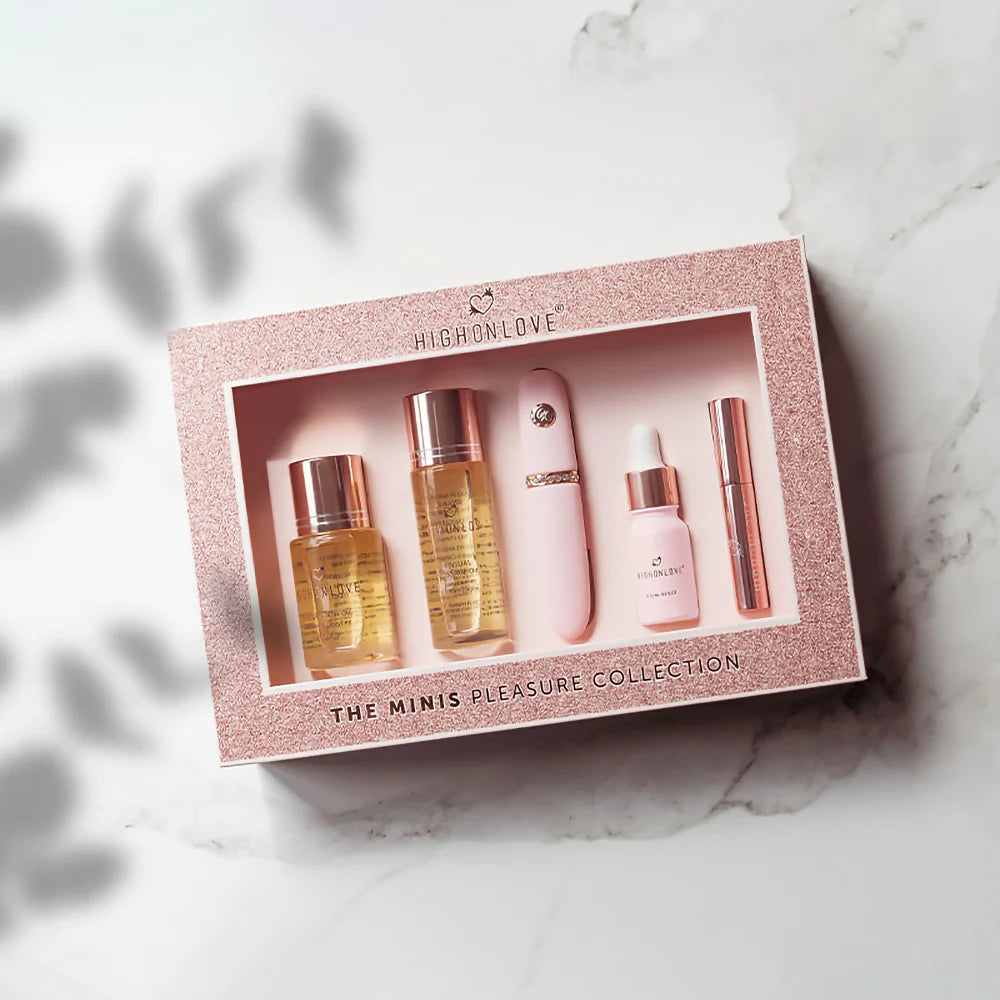 Mini fragrance set in rose-gold glitter box with four bottles and a rose-gold stick.