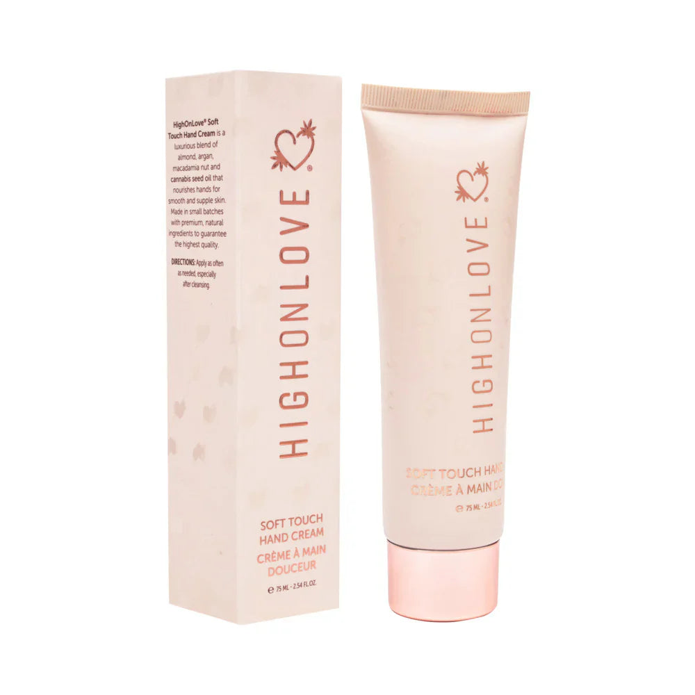 Light pink hand cream tube beside box, heart-flower logo on both
