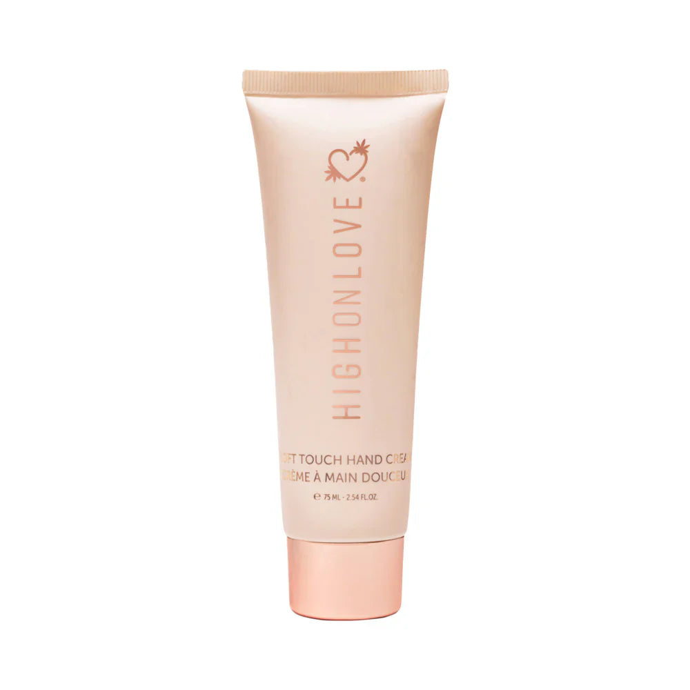 Light pink hand cream tube with ribbed cap and vertical brand logo