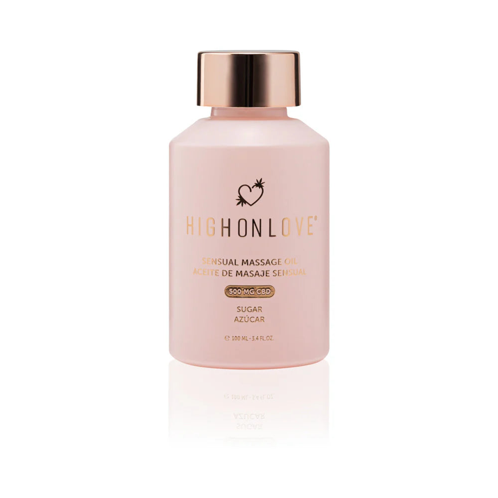 Pink massage oil bottle with gold cap and printed label, front view
