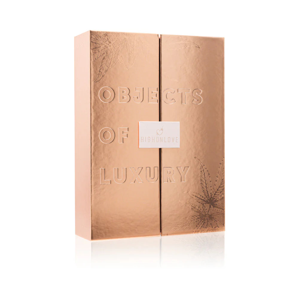Gold-toned gift box with embossed text and small centered label