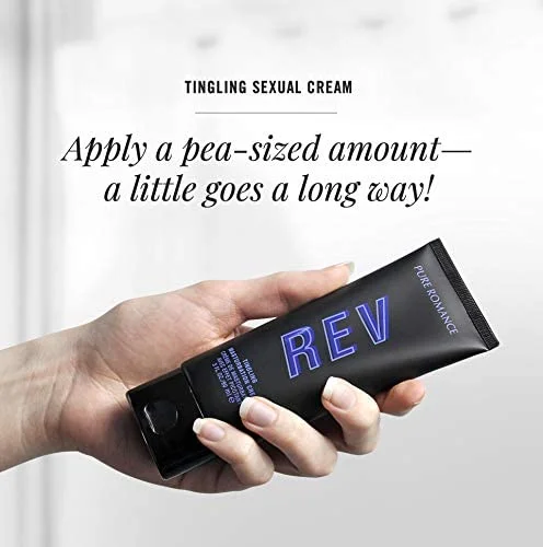 Hand holding black tingling sexual cream tube with blue REv lettering