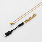 Gold cylindrical bar pendant necklace with chain and connector end