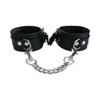 Black ankle cuffs with metal rings, snap closure, and attached chain links