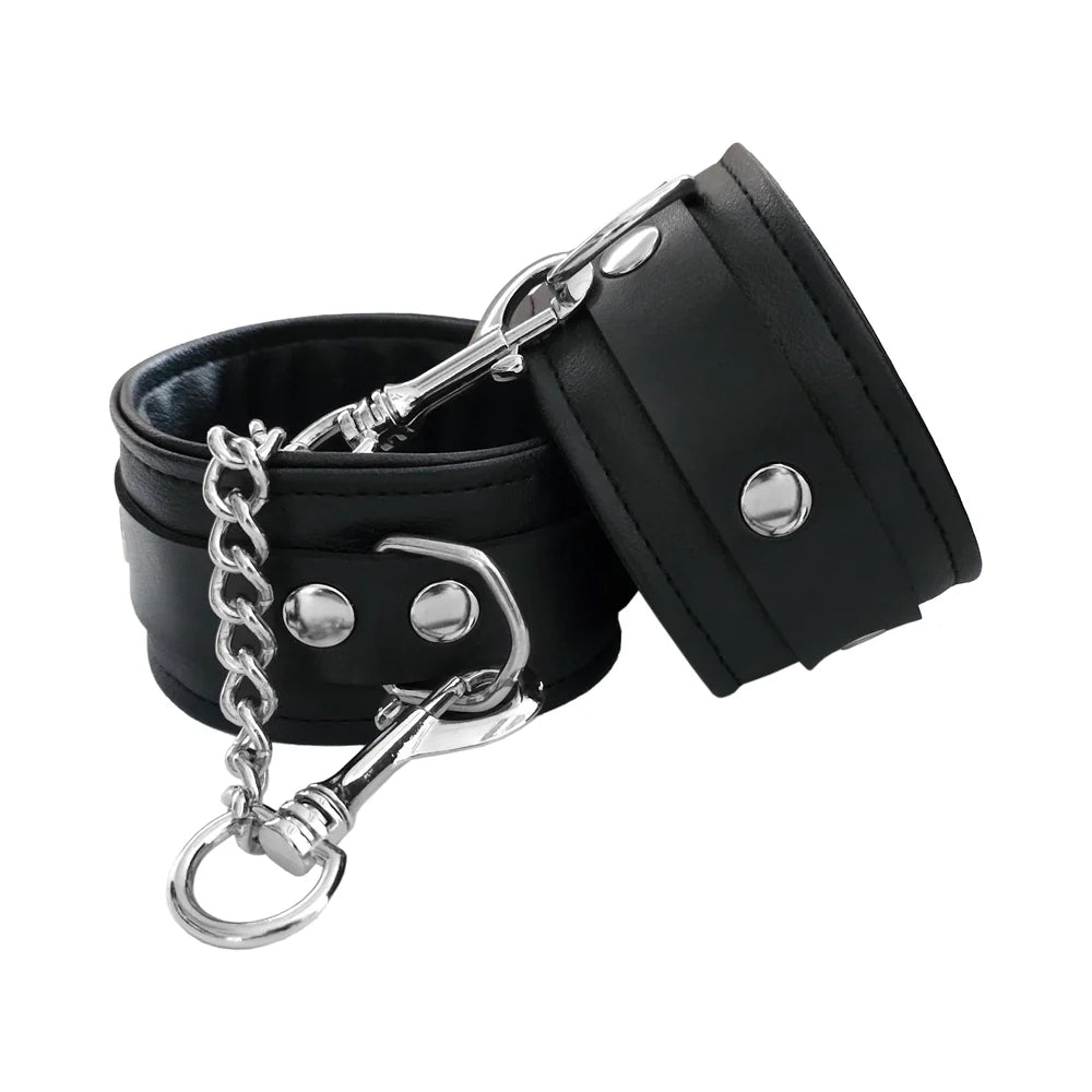 Black vegan wrist cuffs with metal O-ring, chain, and snap clasp