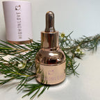 Rose gold oil bottle with HIGHONLOVE heart label and dropper top