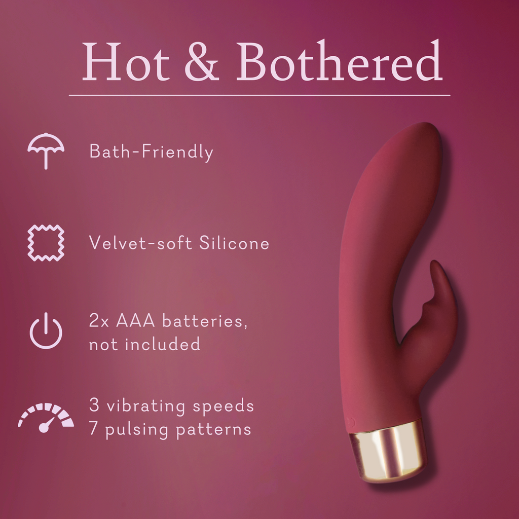 Pink silicone personal massager with curved dual tips and gold-tone base