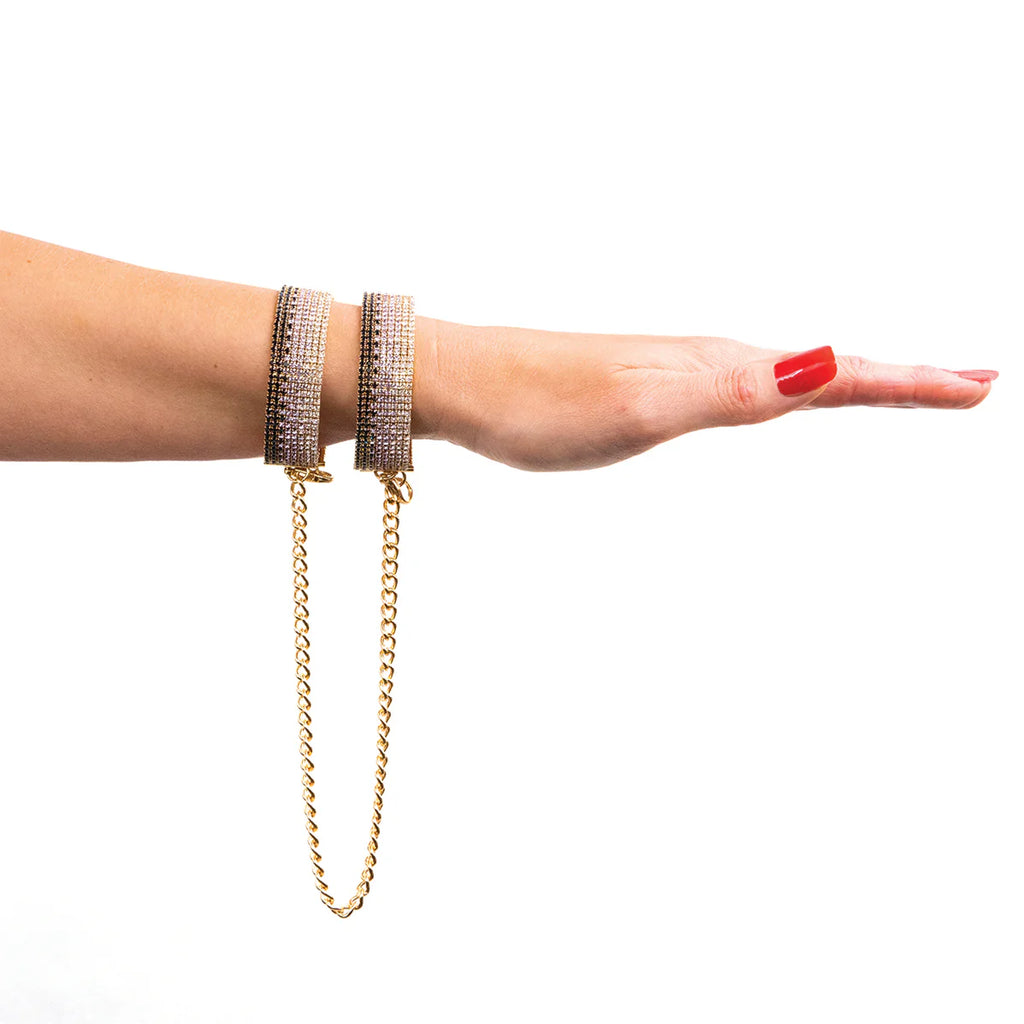 Crystal rhinestone handcuff on wrist with gold chain and clasp