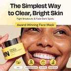 Vitamin C clay mask jar with pale yellow cream, held beside face.