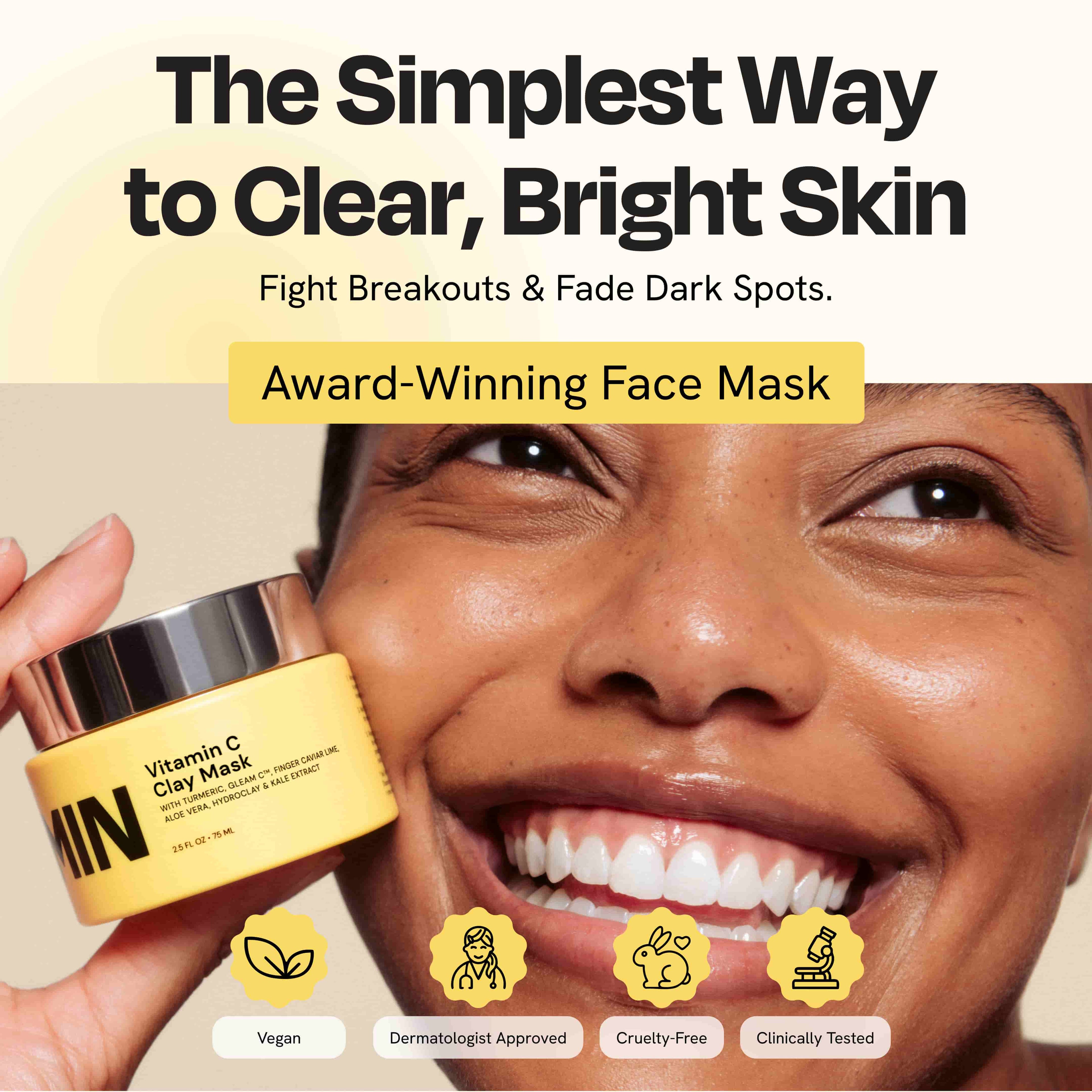 Vitamin C clay mask jar with pale yellow cream, held beside face.