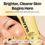 Hand holding yellow cleanser tube near cheek, showing front label and cap