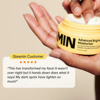 Brightening moisturizer jar held in an open palm, yellow container close-up