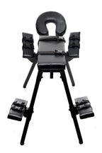 Black padded sex bench with circular headrest and four side restraint arms