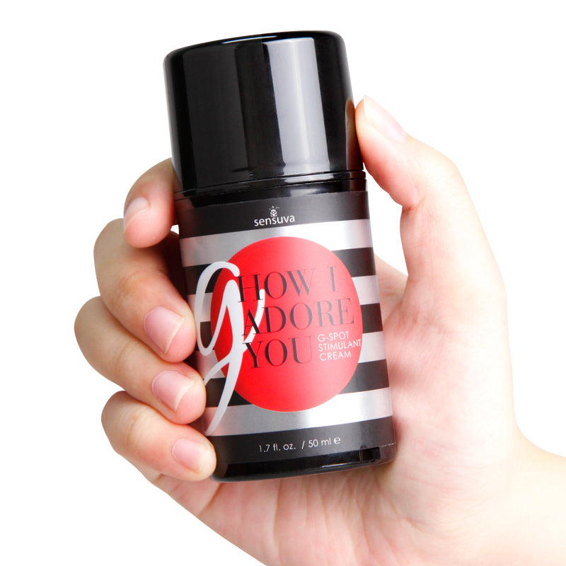 G-Spot enhancement gel bottle held in hands, black cap and striped label