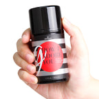 G-Spot enhancement gel bottle held in hands, black cap and striped label