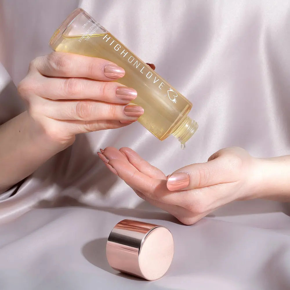 High Love massage oil bottle in hand, pouring onto an open palm