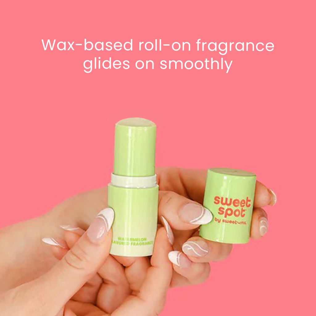 Green roll-on fragrance stick with matching cap held in hand