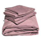 Pink liquid velvet sheet and pillowcases set, folded layers with shiny velvet finish.