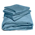 Blue liquid velvet sheet and pillowcases set, neatly folded with glossy sheen folds.