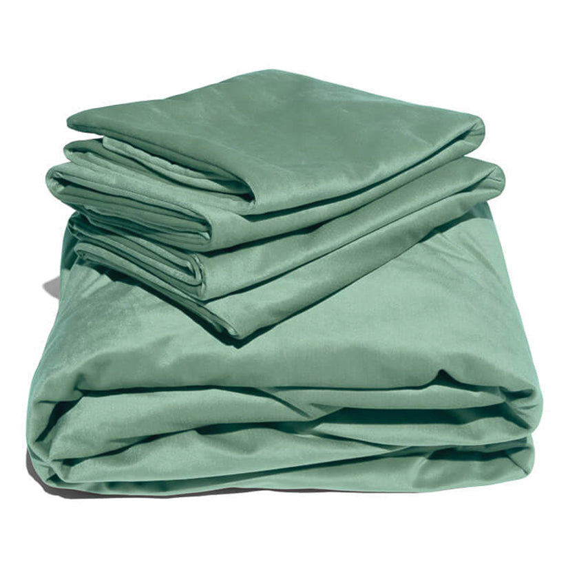Green liquid velvet sheet set with two matching pillowcases, folded.