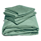 Green liquid velvet sheet set with two matching pillowcases, folded.