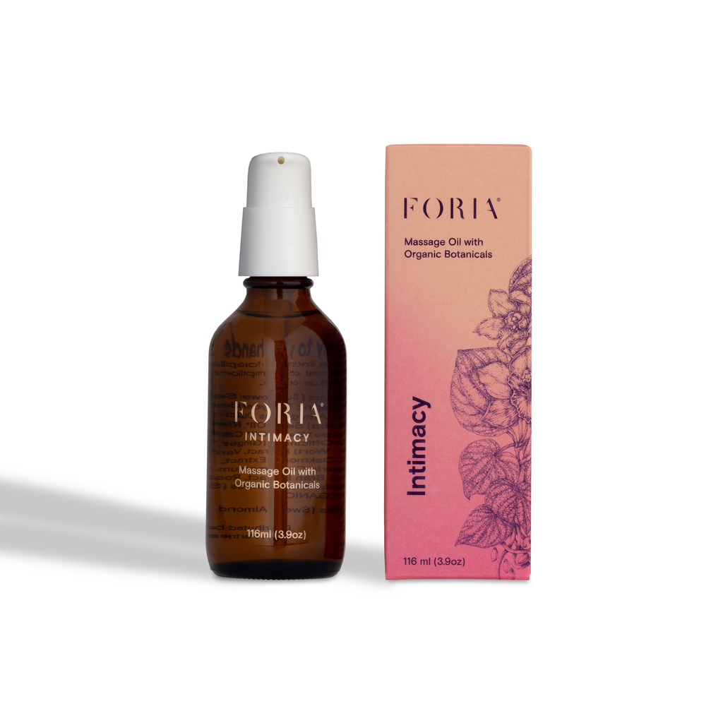 Massage oil bottle with white pump and pink box, amber liquid inside