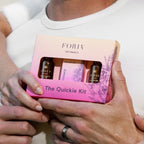 Foria Intimacy The Quickie Kit box with window, held by hands