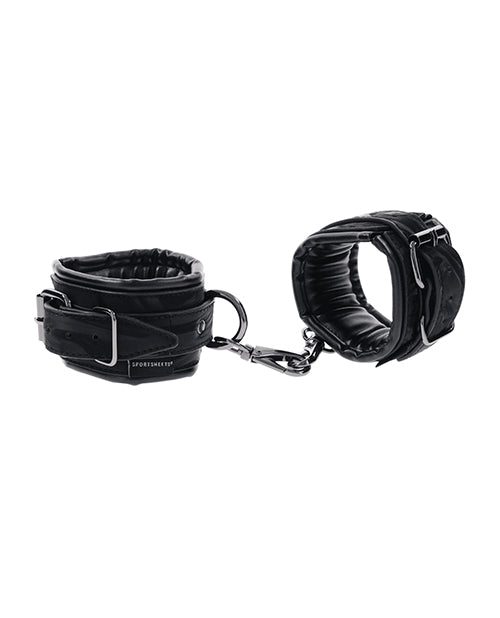 Black velvet handcuffs with chain and two cuff pads, angled close-up.